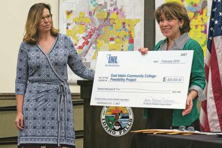 Stephanie Cook of the Idaho National Laboratory presents a research donation to Idaho Falls Mayor Rebecca Casper during a news conference announcing the city’s community college citizen study panel. Kevin Trevellyan /ktrevellyan@postregister.com